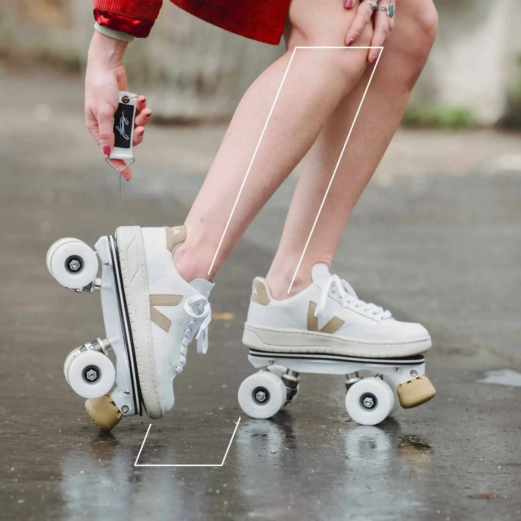 a girl wearing roller skates veja and holding flaneurz key